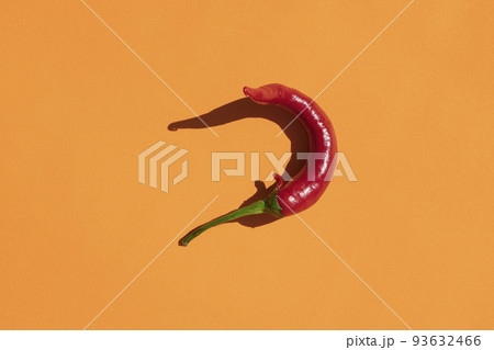 red hot pepper on a yellow background with a hard shadow red hot pepper on a yellow background with a hard shadow 93632466