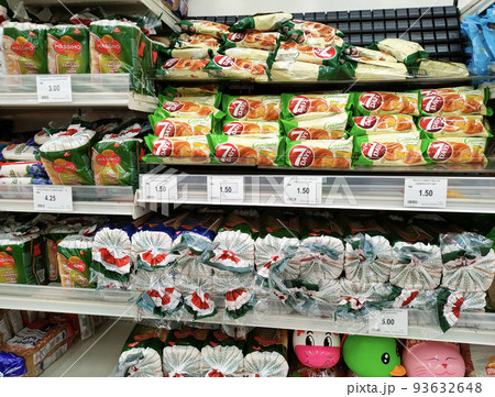 SEREMBAN, MALAYSIA -APRIL 28, 2020: Various types of bread in commercial packaging displayed on shelves for sale. Separated by type and brand to make it easier for customers to choose. 93632648