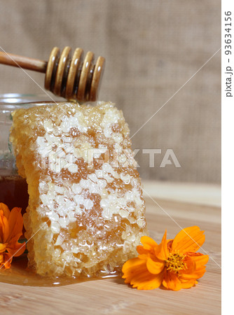 Fresh Honey With Honeycomb and Flowers in Rustic Kitchen 93634156