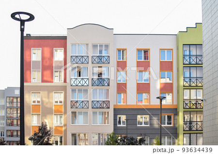 The stylish facade of a residential building with beautiful windows is a new multi-apartment residential quarter of European houses. The stylish facade of a residential building with beautiful windows is a new multi-apartment residential quarter of European houses. 93634439