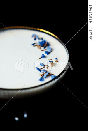 Alcoholic drink. A cocktail with elite alcohol on dark black background, close-up. Alcoholic drink. A cocktail with elite alcohol on dark black background, close-up. 93634905