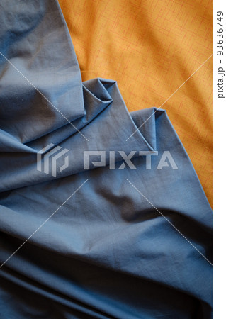 Bicolor background gray orange fabric, crumpled fabric folds, selective focus Bicolor background gray orange fabric, crumpled fabric folds, selective focus 93636749