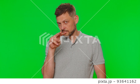 Handsome man pointing at his eyes and camera, show I am watching you gesture, spying on someone Handsome man pointing at his eyes and camera, show I am watching you gesture, spying on someone 93641162