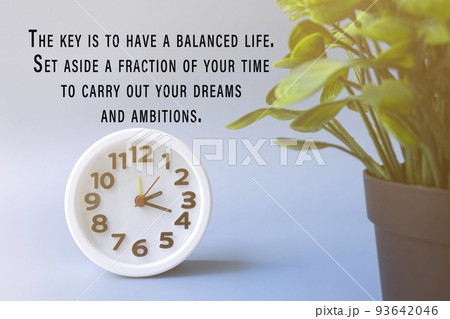 Motivational and inspirational quote with white alarm clock and potted plant. 93642046