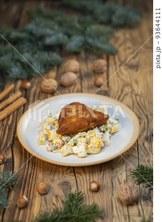 Traditional Christmas dinner in Czech Republic - carp fillet with potato salad Traditional Christmas dinner in Czech Republic - carp fillet with potato salad 93644111