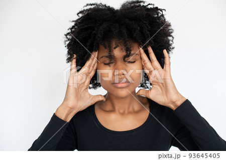 Close-up of African American woman rubbing head 93645405