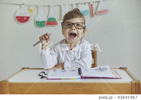 Charming child plays pretending to be a teacher Charming child plays pretending to be a teacher 93645967