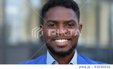 Black businessman enjoys occupation showing toothy smile Black businessman enjoys occupation showing toothy smile 93646036