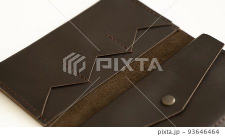 Opened empty brown natural genuine leather wallet isolated on white background. Expensive man's purse closeup. Opened empty brown natural genuine leather wallet isolated on white background. Expensive man's purse closeup. 93646464