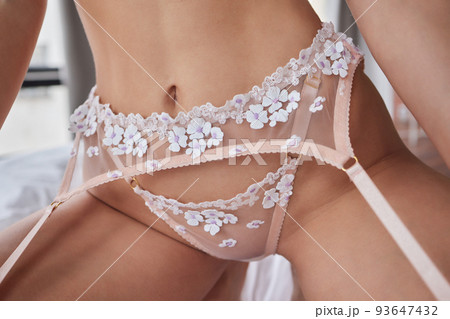 Young woman on her bed wearing white underwear. 93647432