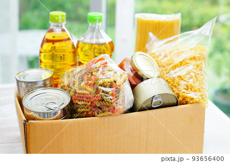 Foodstuffs in donation box for volunteer. Foodstuffs in donation box for volunteer. 93656400