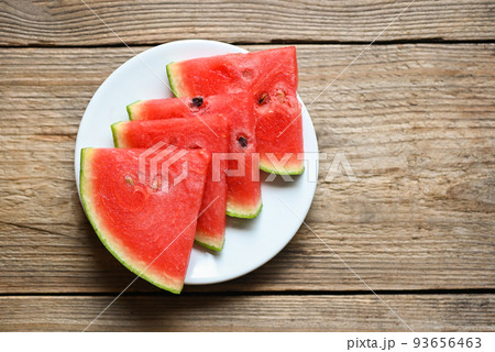 Watermelon slice on white plate background, Closeup sweet watermelon slices pieces fresh watermelon tropical summer fruit Watermelon slice on white plate background, Closeup sweet watermelon slices pieces fresh watermelon tropical summer fruit 93656463