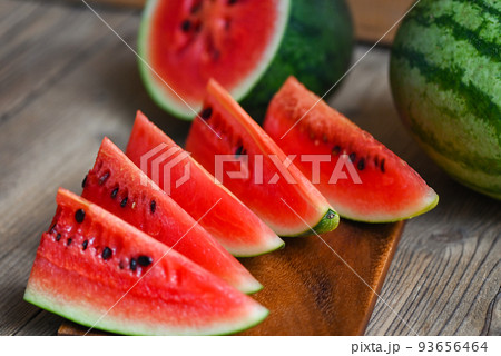 Watermelon slice on wooden background, Closeup sweet watermelon slices pieces fresh watermelon tropical summer fruit Watermelon slice on wooden background, Closeup sweet watermelon slices pieces fresh watermelon tropical summer fruit 93656464