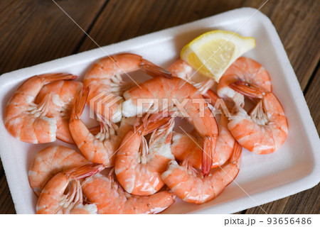Seafood fresh shrimps on on plate plastic tray with lemon, boiled shrimp prawns cooked food, order food to go home takeaway restaurants food delivery concept Seafood fresh shrimps on on plate plastic tray with lemon, boiled shrimp prawns cooked food, order food to go home takeaway restaurants food delivery concept 93656486