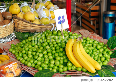 Fruit market counter with assortment of fresh fruits for sale 93657202