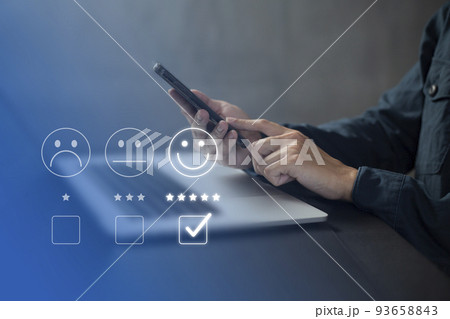 Satisfaction and customer service survey concept, business people using  smartphone. to answer the questionnaire And the satisfaction rating, the satisfaction rating with the smiley face icon 5 stars. 93658843