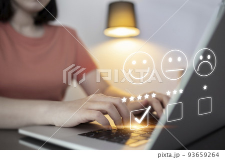 Satisfaction and customer service survey concept, business people using  laptop. to answer the questionnaire And the satisfaction rating, the satisfaction rating with the smiley face icon 5 stars. 93659264
