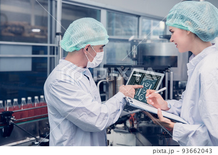 Food and Drink factory worker working together with hygiene monitor control mix ingredients machine with laptop computer Food and Drink factory worker working together with hygiene monitor control mix ingredients machine with laptop computer 93662043