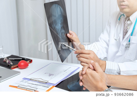 Medical and health care  concept. Doctor explaining x-ray results to patient while sitting at the table in office. 93662086