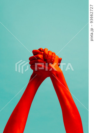 Friendship. Authentic hands gesturing isolated on cyan color background in red neon light. Concept of relationship, community, care, support, symbolism, culture 93662727
