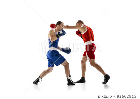 Dynamic portrait of two professional boxer in sports uniform boxing isolated on white background. Concept of sport, competition, training, energy 93662915
