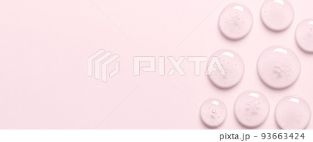 Pink drops of gel closeup. Cosmetic product for moisturizing the skin of the face or body. 93663424
