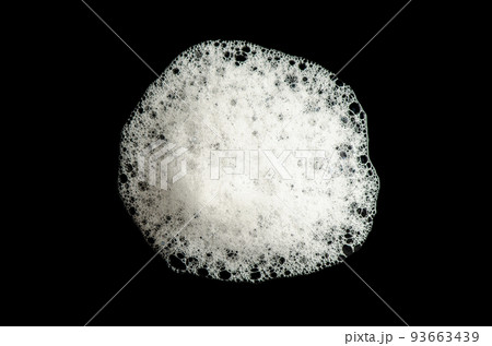 Texture of white foam on a black background. Cleansing mousse for the face or shower gel or washing powder. Isolated on a black background. 93663439