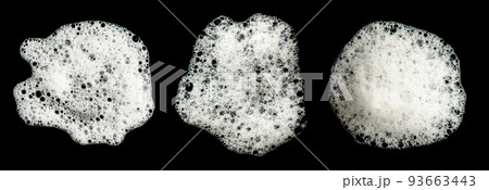 Texture of white foam on a black background. Cleansing mousse for the face or shaving foam or washing powder. Isolated on a black background. Texture of white foam on a black background. Cleansing mousse for the face or shaving foam or washing powder. Isolated on a black background. 93663443