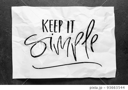 Keep it simple. Lettering on crumpled white paper. Handwritten text. Inspirational quotes. Keep it simple. Lettering on crumpled white paper. Handwritten text. Inspirational quotes. 93663544