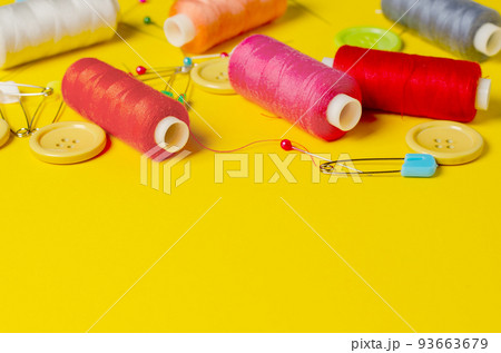 Sewing accessories on a yellow background. Closeup. Copy space 93663679