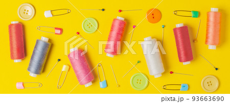 Sewing accessories on a yellow background. Closeup. 93663690