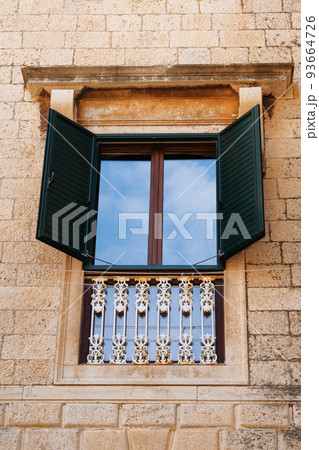 Window in an old historic building. Retro architecture. Summer in Croatia. Dubrovnik Window in an old historic building. Retro architecture. Summer in Croatia. Dubrovnik 93664726