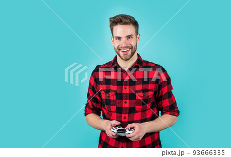 handsome man play with game console. modern technology and engineering. video game console. guy playing on console. it is my hobby. inveterate gamer. time for party fun handsome man play with game console. modern technology and engineering. video game console. guy playing on console. it is my hobby. inveterate gamer. time for party fun 93666335
