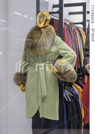 Mannequins in coat natural fur stand in a clothing store. Female mannequins in the big mall. 93666411