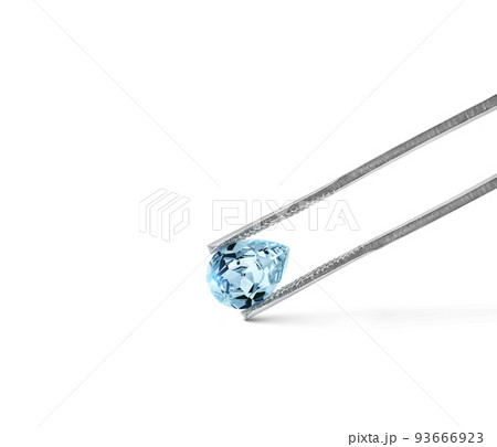 blue diamonds held in tweezers on a white background 93666923