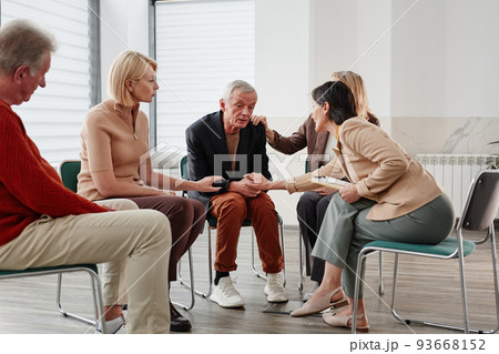 People talking to depressed man People talking to depressed man 93668152
