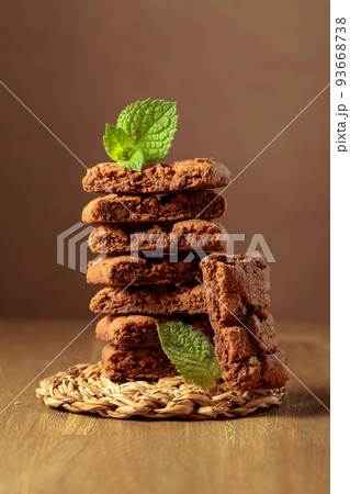 Brownie with mint on a wooden table. Brownie with mint on a wooden table. 93668738