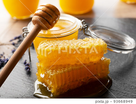 Honeycomb on slate tray on kitchen table closeup Honeycomb on slate tray on kitchen table closeup 93668949