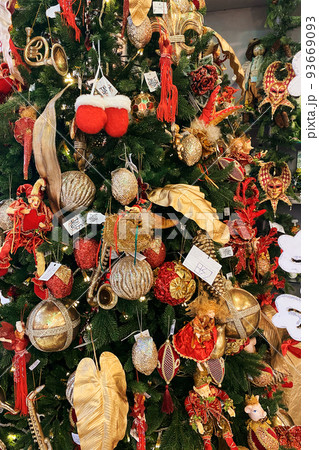 Christmas toys and souvenirs for decoration prepared for sale in supermarket. Variety of colorful decoration in large shopping center. New Year. Christmas toys and souvenirs for decoration prepared for sale in supermarket. Variety of colorful decoration in large shopping center. New Year. 93669093