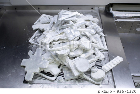 Detail objects printed on powder 3D printer and covered white polyamide powder close-up. Technology Multi Jet Fusion MJF. 3D prototype models created by new additive progressive 3d printing technology 93671320