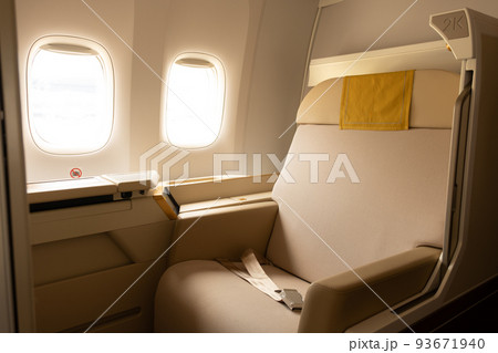 Luxury first class or business class suite on airplane in gold color feel private for travel. Business comfort and eleglance chair when fly with airline. 93671940