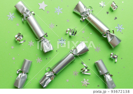 Christmas crackers with shiny confetti on color background, top view, copy space Christmas crackers with shiny confetti on color background, top view, copy space 93672138