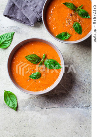Traditional gaspacho in gray bowl. Summer tomato soup with basil. Traditional gaspacho in gray bowl. Summer tomato soup with basil. 93672335