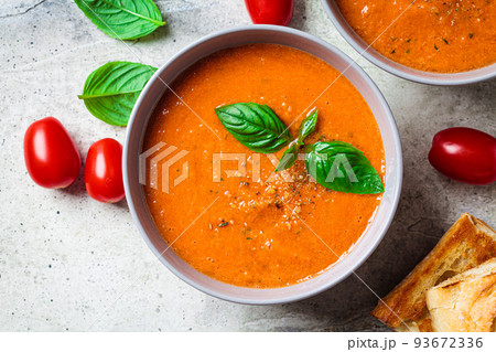 Traditional gaspacho in gray bowl. Summer tomato soup with basil. Traditional gaspacho in gray bowl. Summer tomato soup with basil. 93672336