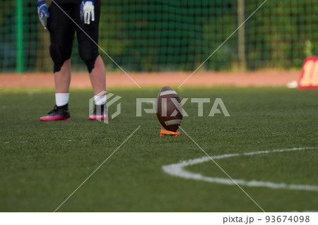 Ball for american football on green grass Ball for american football on green grass 93674098