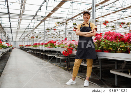 Happy woman florist in greenhouse Happy woman florist in greenhouse 93674325