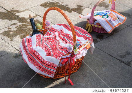Easter Orthodox basket with Easter cake prepared for consecration in the church. Traditional Ukrainian patterns on towels. 93674527