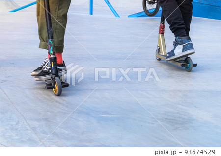 Skater boys having fun practicing at the outdoors skate park on a summer day. Active urban life. Urban subculture. Copy space. Skater boys having fun practicing at the outdoors skate park on a summer day. Active urban life. Urban subculture. Copy space. 93674529