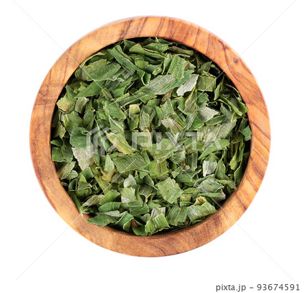 Dry chopped spring onion in wooden bowl, isolated on white background. Dried green onion or scallion. Spices and herbs. Top view. 93674591