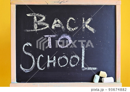 Blackboard - back to school. Concept for education and school on yellow background. Blackboard - back to school. Concept for education and school on yellow background. 93674882